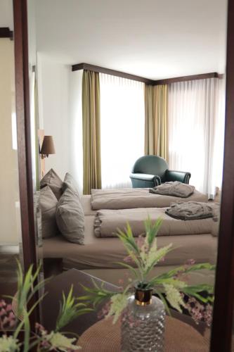 a hotel room with two beds and a mirror at Hotel Habichtstein in Alexisbad