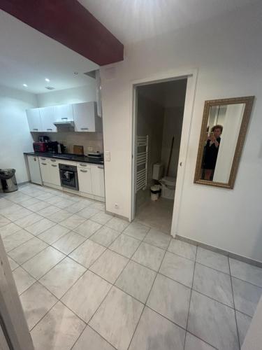 a person is taking a picture of a kitchen at Location saisonnière in Sospel
