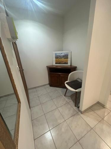 a hallway with a chair and a desk in a room at Location saisonnière in Sospel