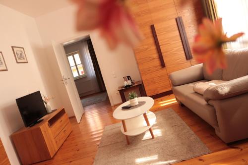 a living room with a couch and a table at Hotel Habichtstein in Alexisbad