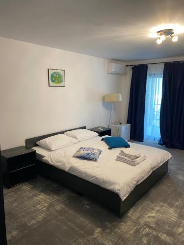 a bedroom with a large bed with two pillows on it at Vama Stone House in Vama Veche
