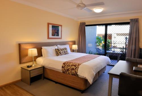 a hotel room with a bed and a balcony at Quest Ascot in Brisbane