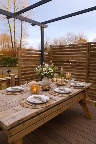 a wooden table with plates and food on it at Chez Achille in Marcilly-sur-Eure