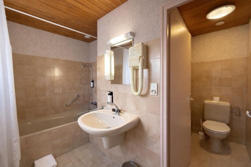 a bathroom with a sink and a toilet at L'Echo des Montagnes Armoy in Armoy
