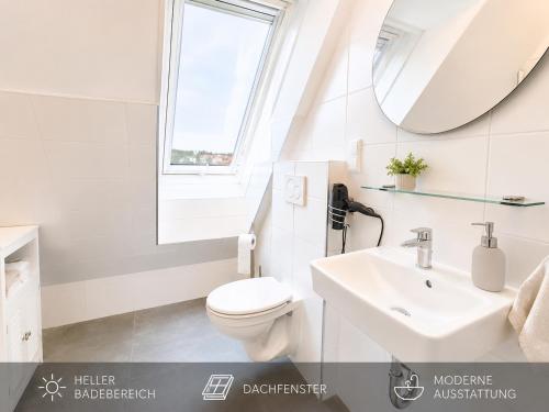 a white bathroom with a toilet and a sink at Ort 245 in Ried im Innkreis