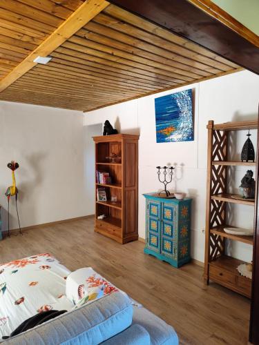 a bedroom with a bed and a wooden ceiling at Cocon de Grand Anse in Petite Île