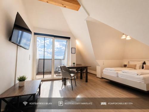 a bedroom with a bed and a table with a dining room at Ort 245 in Ried im Innkreis