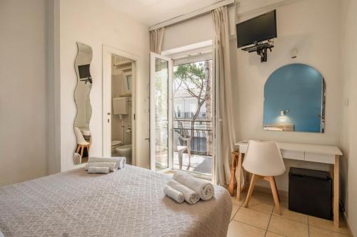 a bedroom with a bed with towels on it at Hotel Arlecchino Riccione in Riccione