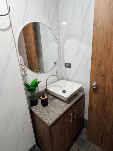 a bathroom with a sink and a mirror at Villa Celeste Guaduas El Mirador in Guaduas