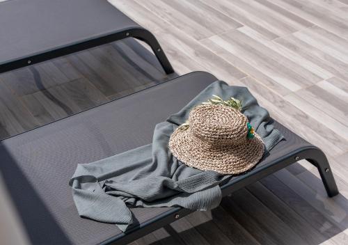 a hat sitting on a bed with a blanket at Kalkan Beach Park Hotel in Kaş