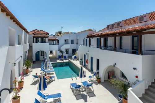 a view of the courtyard of a hotel with a swimming pool at Iliana Hotel in Panormos Rethymno