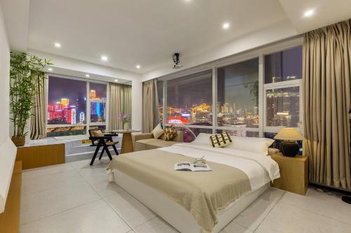 a bedroom with a large bed and a large window at Guyu B&B in Chongqing