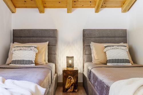 two beds sitting next to each other in a bedroom at Villa Aegea in Skopelos Town