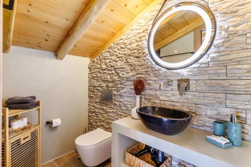 a bathroom with a sink and a mirror at Villa Aegea in Skopelos Town