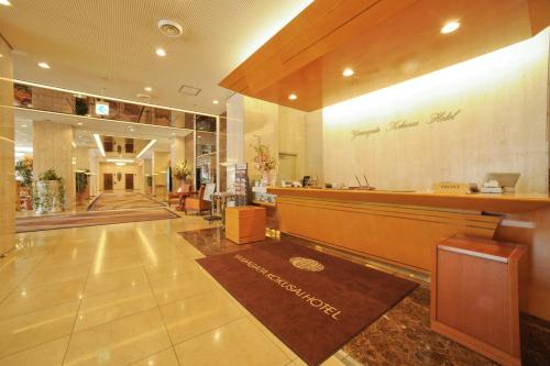 a lobby of a hotel with a reception desk and a lobby at Yamagata Kokusai Hotel in Yamagata