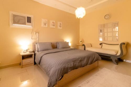 a bedroom with a bed and a chair in it at HOMEY iNN in Medina