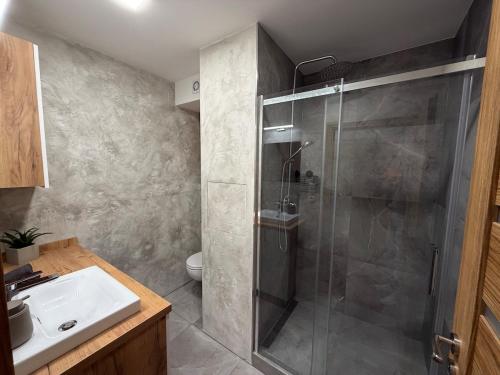 a bathroom with a shower and a sink at Modern stylish apartment in Prievidza