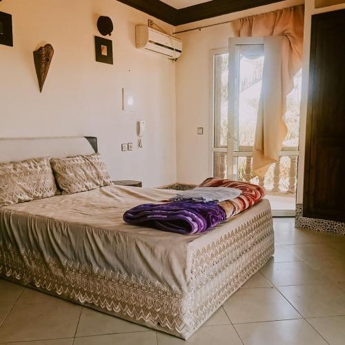 a large bed in a room with a window at reda land in Ben Slimane
