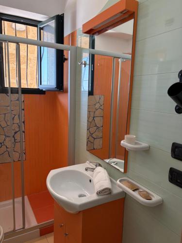 a bathroom with a sink and a mirror at Villa Arneide bed and breakfast in Torre Lapillo