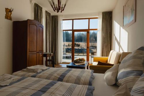 a hotel room with two beds and a window at Biosfera Klingeis in Avrig