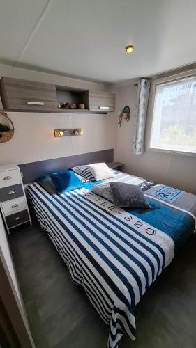 a bedroom with a large bed in a room at Mobil-home DURIS in Hyères