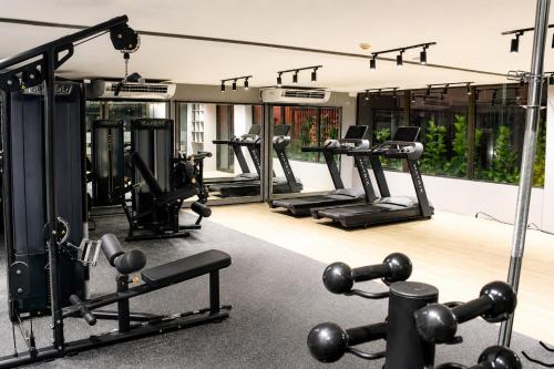 a gym with several treadmills and exercise machines at Jardins Almare Apart Hotel in João Pessoa