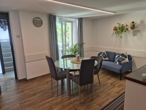 a living room with a table and chairs and a couch at Casa Rosa in Biasca