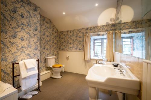a bathroom with a sink and a toilet at Askham Hall in Askham