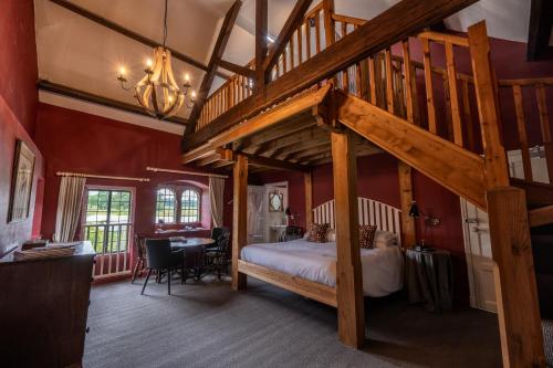 a bedroom with a loft bed with a wooden ladder at Askham Hall in Askham