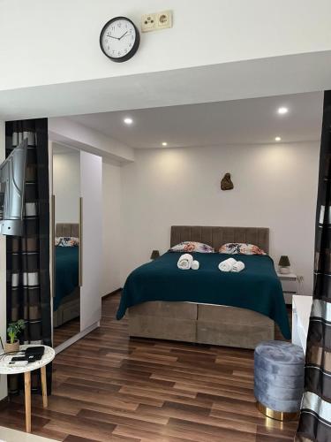 a bedroom with a bed and a clock on the wall at JUDITA in Omiš