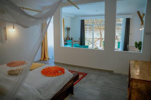 a bedroom with a bed and a large window at Pemba Paradise in Makangale
