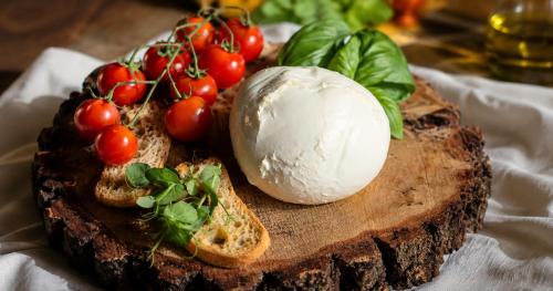 a plate of food with bread and tomatoes on it at Medea Beach Resort - Cultural Stay near Amalfi Coast & Paestum in Paestum