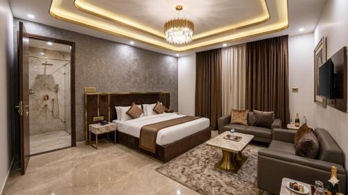 a hotel room with a bed and a couch at Hotel Tela Suite Near IGI Airport Delhi in New Delhi