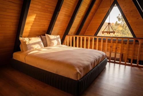 a bed in a room with a large window at Morrian Sapanca in Sapanca