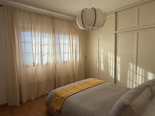 a bedroom with a bed and a large window at Fajana de Trevejo in Garachico