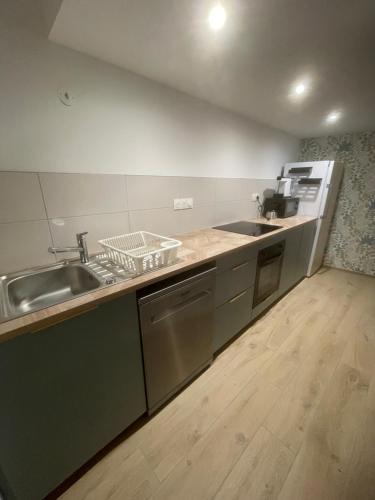 a kitchen with a sink and a counter top at Chez Mamema in Barr