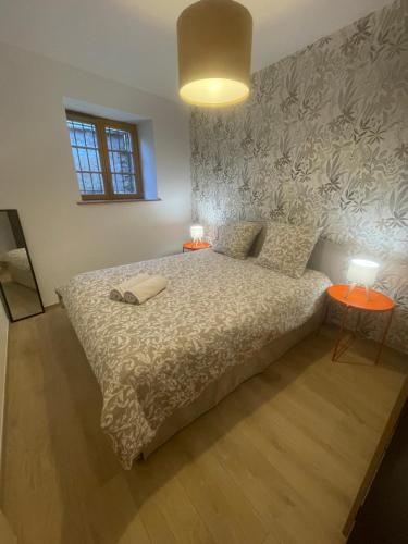 a bedroom with a bed and two tables with lamps at Chez Mamema in Barr
