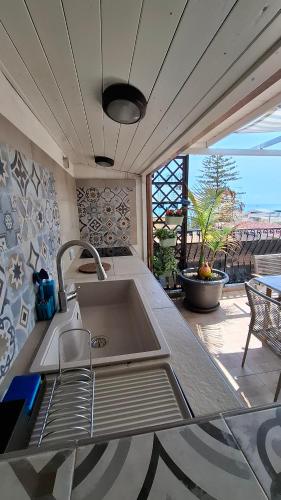 a kitchen with a sink and a counter top at Terrazza Enjoy in Letojanni