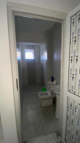 a bathroom with a toilet and a sink at Mombasa city view in Mombasa