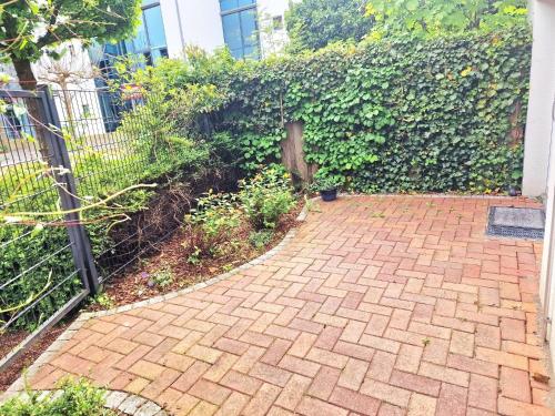 a brick walkway in front of a fence at Fördequartier Stadtloft Flensburg in Flensburg