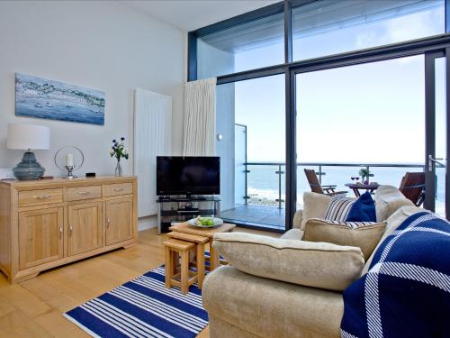 a living room with a couch and a television at Bliss - Horizon View in Westward Ho