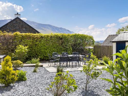 a patio with a table and chairs in a garden at Mount Pleasant in Threlkeld
