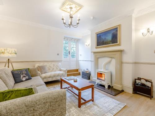 a living room with a couch and a fireplace at Eagles Nest At Greyfriars - Uk33356 in Winchelsea