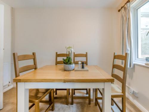 a dining room table and chairs in a room at Pine Cottage - Uk46874 in Hartland