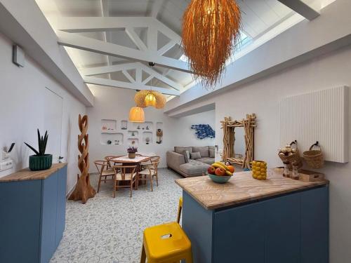 a kitchen and living room with a table and a couch at Villa Metaxa Barbati Beach Corfu in Barbati