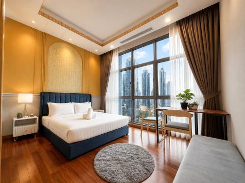 a bedroom with a bed and a desk and a window at Royce Residence KLCC by Dormeo Destinations in Kuala Lumpur