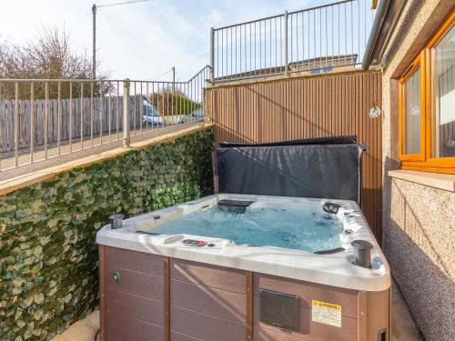 a hot tub sitting on the side of a building at The Beaches in Berwick-Upon-Tweed