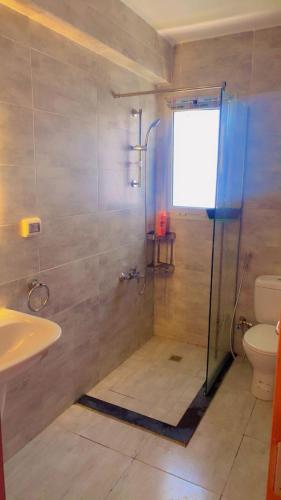 a bathroom with a shower and a sink and a toilet at MV Ras El Hakma 190 A in Ras Elhekma