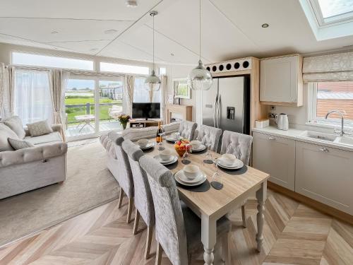 a kitchen and dining room with a table and chairs at Reel Paradise - Uk37723 in Ingoldmells