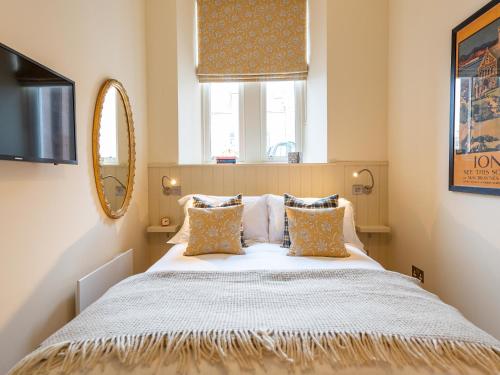 a bedroom with a large bed with a mirror at Croft House - Uk7555 in Inverness